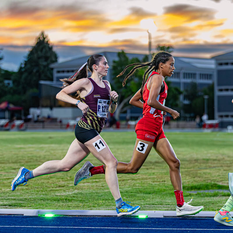 Female Athletes Competing in a Track Race | Performance Coaching Female athletes competing in a middle-distance track race, demonstrating focus, resilience and peak performance under pressure, qualities developed through performance coaching.